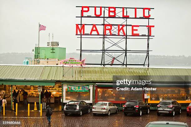 the pike place market during winter in the rain. - seattle market stock pictures, royalty-free photos & images