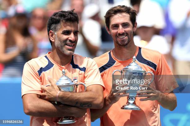 Maximo Gonzalez and Andres Molteni of Argentina pose with the trophy after defeating Mackenzie McDonald and Ben Shelton of the United States to win...