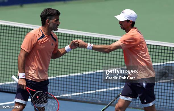 Maximo Gonzalez and Andres Molteni of Argentina celebrate winning a point against Mackenzie McDonald and Ben Shelton of the United States during the...