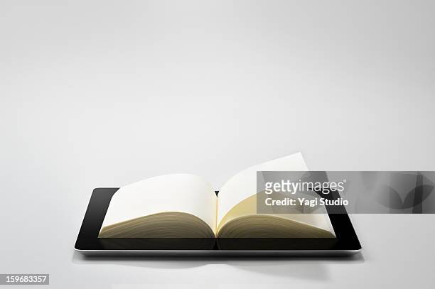book on a digital tablet. - lector de libros electrónicos fotografías e imágenes de stock