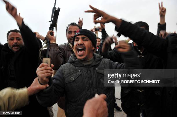 Libyans at the rebel-held eastern town of Brega celebrate after rumor spread that their fighters took over the town of Ras Lanuf from pro-Kadhafi...