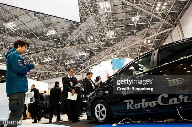 The Microsoft Corp. And ZMP Inc. Logos are displayed on a Cloud RoboCar RoboCar PHV vehicle at Automotive World 2013 in Tokyo, Japan, on Friday, Jan....