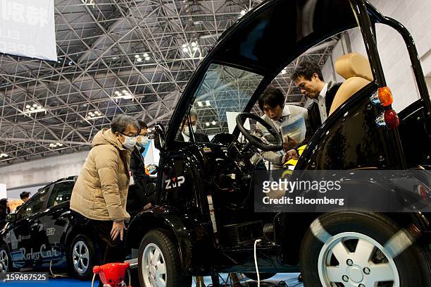 Visitors inspect a ZMP Inc. Car Robotics Platform Robocar MV2 vehicle at Automotive World 2013 in Tokyo, Japan, on Friday, Jan. 18, 2013. The...