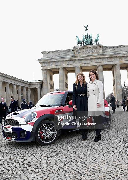 Princess Beatrice and Princess Eugenie pose next to a Mini in front of Brandenburg Gate as they promote the GREAT initiative on January 17, 2013 in...