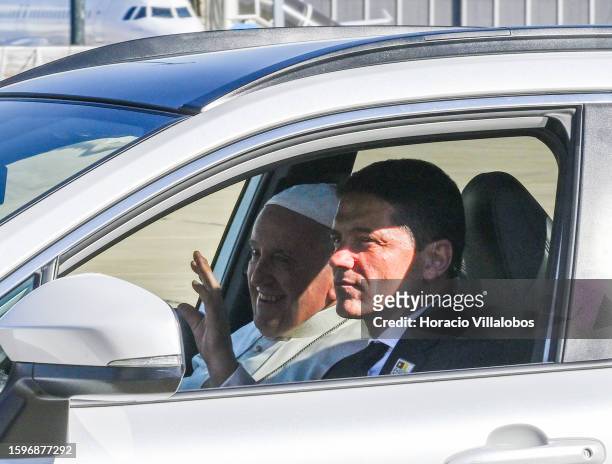 Pope Francis smiles and waves from the front passenger seat of his Toyota vehicle while arriving in Figo Maduro Military Airport to fly back to Rome...