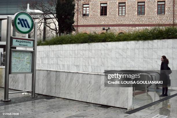 Woman stands at a closed subway station in Athens due to a 24-hours emloyees strike on January 18, 2013. Athens metro, tram and urban railway workers...