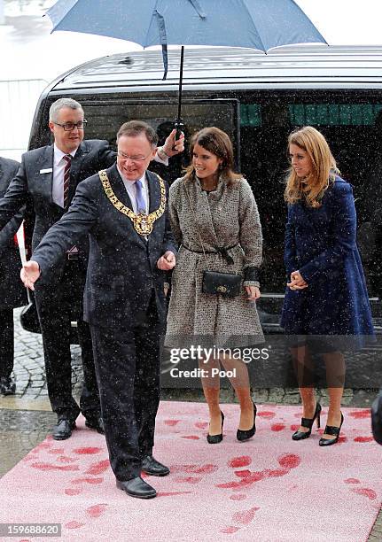 Princess Beatrice and Princess Eugenie are greeted by The Mayor of Hanover Stephan Weil as they arrive at Hanover City Hall on January 18, 2013 in...