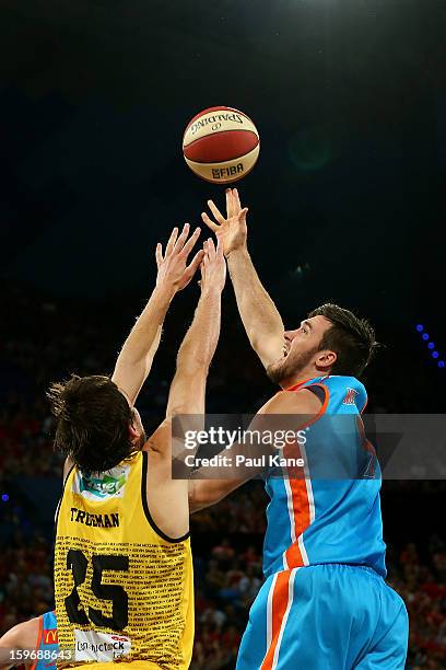 Jeremiah Trueman of the Wildcats atempts to block a shot by Brad Hill of the Taipans during the round 15 NBL match between the Perth Wildcats and the...