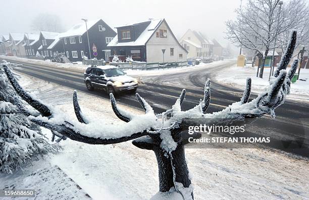 Statue is covered with snow in Neuhaus am Rennweg, Germany, on January 18, 2013. Throughout Germany the weather is dominated by snow and frosty...