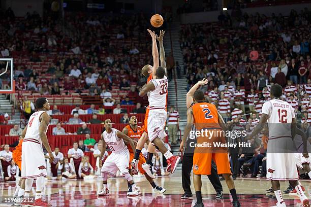 Rob Chubb of the Auburn Tigers goes up for the first overtime tip off against Marshawn Powell of the Arkansas Razorbacks at Bud Walton Arena on...