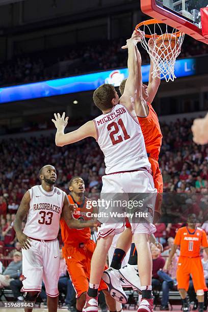 Rob Chubb of the Auburn Tigers dunks over Hunter Mickelson of the Arkansas Razorbacks at Bud Walton Arena on January 16, 2013 in Fayetteville,...
