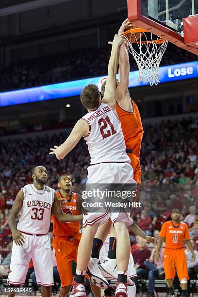 Rob Chubb of the Auburn Tigers dunks over Hunter Mickelson of the Arkansas Razorbacks at Bud Walton Arena on January 16, 2013 in Fayetteville,...