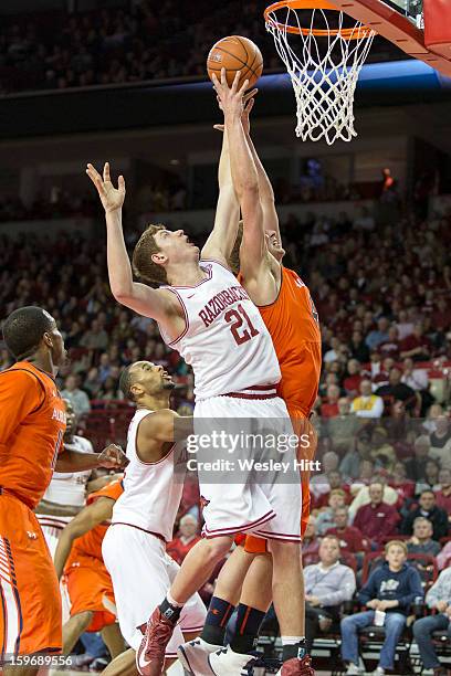 Hunter Mickelson of the Arkansas Razorbacks goes up for a rebound against Rob Chubb of the Auburn Tigers at Bud Walton Arena on January 16, 2013 in...