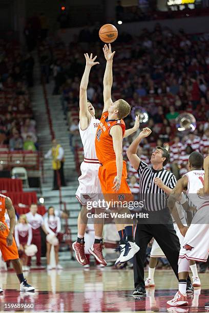 Rob Chubb of the Auburn Tigers goes up for the tip off against Hunter Mickelson of the Arkansas Razorbacks at Bud Walton Arena on January 16, 2013 in...