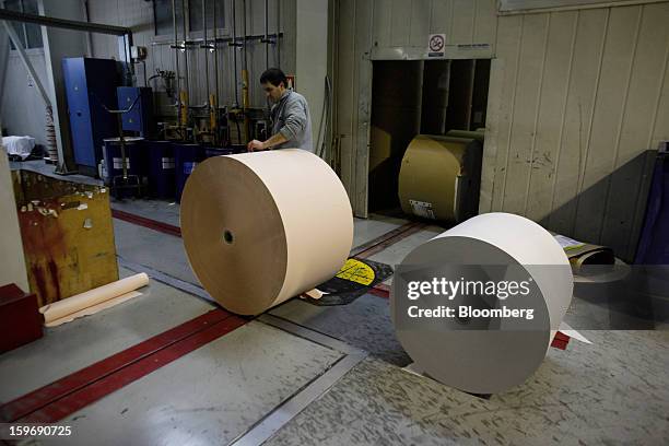 Worker prepares rolls of newsprint paper at the Kathimerini printing plant in Paiania, Greece, on Thursday, Jan. 17, 2013. An anarchist group claimed...