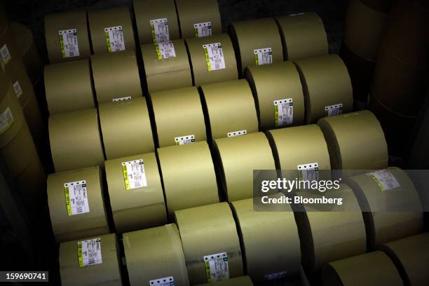 Rolls of newsprint paper stand in a storeroom before use at the Kathimerini printing plant in Paiania, Greece, on Thursday, Jan. 17, 2013. An...