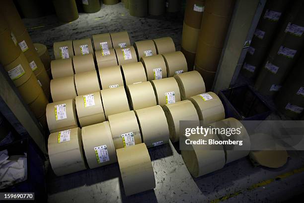 Rolls of newsprint paper stand in a warehouse before use at the Kathimerini printing plant in Paiania, Greece, on Thursday, Jan. 17, 2013. An...