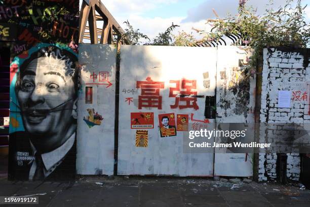 Pro democracy activists and graffiti artists write over Beijing loyalists painted slogans featuring Chinese Communist Partys core ideology on...