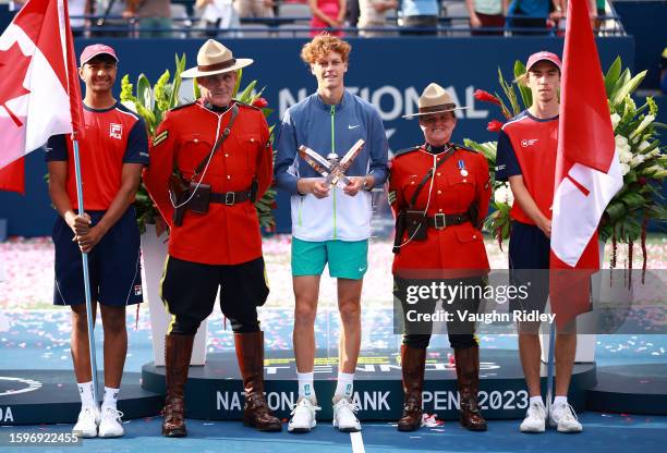 Jannik Sinner of Italy poses with Canadian Mounties after his win against Alex De Minaur of Australia in the Singles Final during Day Seven of the...