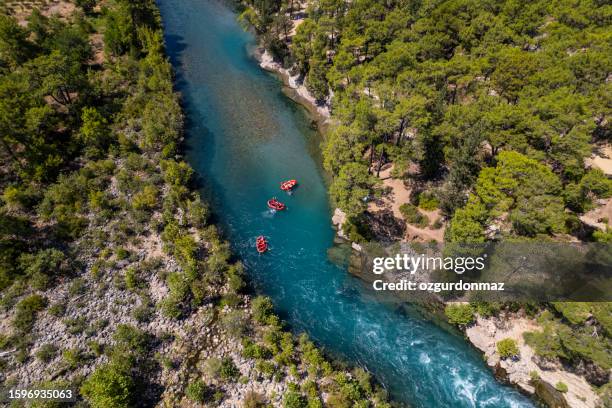 aerial view of group of inflatable rafting boats floating down the river in koprulu canyon, manavgat, antalya - white water rafting stock pictures, royalty-free photos & images