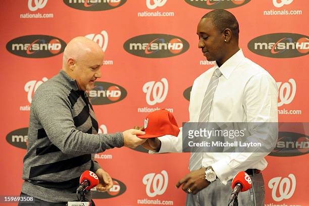 Executive Vice President of baseball operations Mike Rizzo gives Rafael Soriano of the Washington Nationals his new cap during his introduction press...