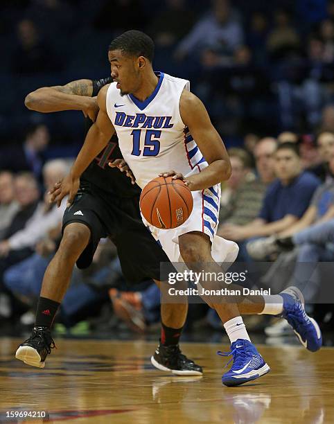 Moses Morgan of the DePaul Blue Demons drives against Jaquon Parker of the Cincinnati Bearcats at Allstate Arena on January 15, 2013 in Rosemont,...