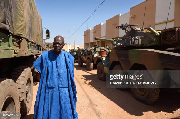 Malian man walks by Sagaie tanks used by French soldiers from the 21st Rima, near the Malian army 101 airbase, where French troops are stationed, on...