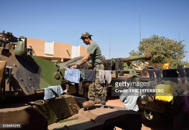 French soldier from the 21st Rima hangs laundry on the barrel of a Sagaie tank, at the Malian army 101 airbase, where French troops are stationed, on...