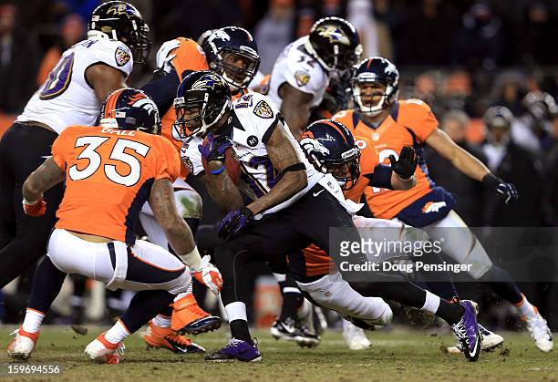 Jacoby Jones of the Baltimore Ravens runs with the ball against Lance Ball of the Denver Broncos during the AFC Divisional Playoff Game at Sports...