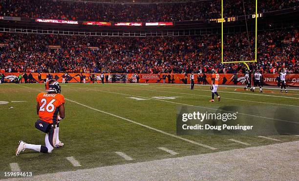 Rahim Moore of the Denver Broncos looks on as Jacoby Jones of the Baltimore Ravens celebrates in the endzone after he scored a 70-yard touchdown...