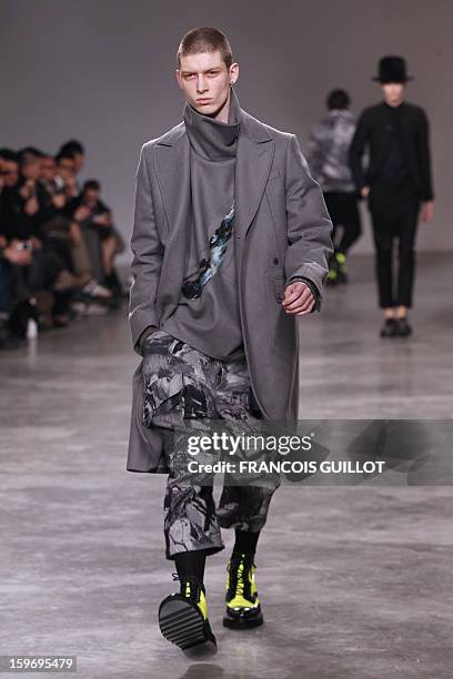 Model presents a creation by British designer Bill Gaytten for the label John Galliano during the men's Fall-Winter 2013-2014 collection show on...