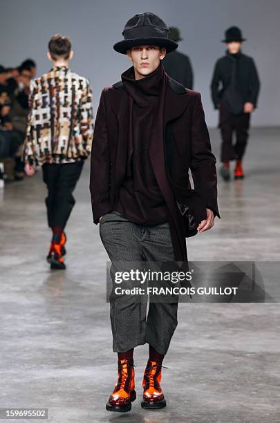 Model presents a creation by British designer Bill Gaytten for the label John Galliano during the men's Fall-Winter 2013-2014 collection show on...