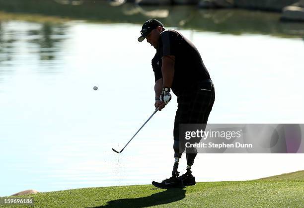 Iraq war veteran and double amputee Saul Martinez chips onto the 13th green as he plays in the pro-am during the second round of the Humana Challenge...