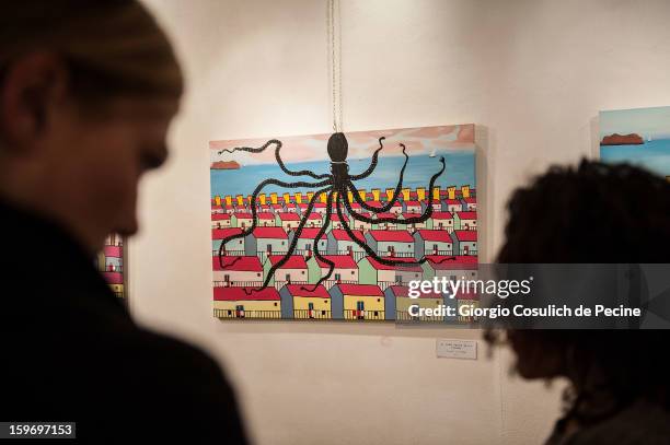 Visitors attend the opening of the exhibition of the paintings of the Mafia turncoat Gaspare Mutolo at Baccina 66 on January 18, 2013 in Rome, Italy.