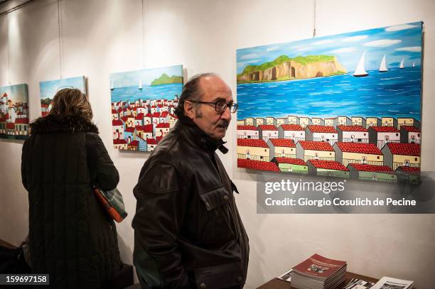 Visitors attend the opening of the exhibition of the paintings of the Mafia turncoat Gaspare Mutolo at Baccina 66 on January 18, 2013 in Rome, Italy.