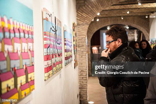 Visitors attend the opening of the exhibition of the paintings of the Mafia turncoat Gaspare Mutolo at Baccina 66 on January 18, 2013 in Rome, Italy.