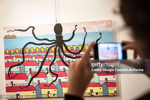 Visitors attend the opening of the exhibition of the paintings of the Mafia turncoat Gaspare Mutolo at Baccina 66 on January 18, 2013 in Rome, Italy.