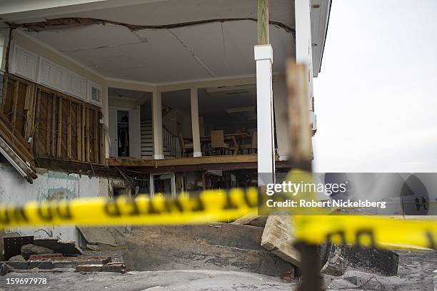 Wood and furnishings lie outside a private seaside residence January 17, 2013 damaged during Hurricane Sandy in the Rockaways January 17, 2013 in the...