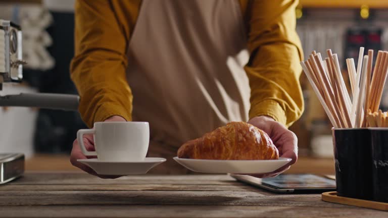 https://media.gettyimages.com/id/1596996017/video/takeaway-food-coffee-artist-getting-a-croissant-order-at-the-counter-in-a-coffee-shop-the.jpg?b=1&s=640x640&k=20&c=FY9Q54HS4fp3gssW2DLIQ_xgYQ3swrcpa4aGtv0OpSw=