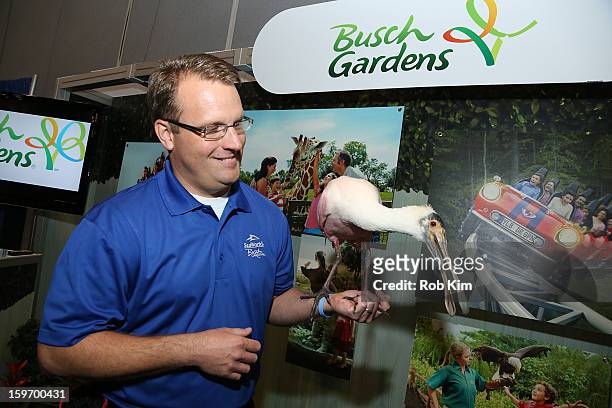 Representative of Busch Gardens holds a bird at The 10th Annual New York Times Travel Show Ribbon Cutting And Preview at Javits Center on January 18,...