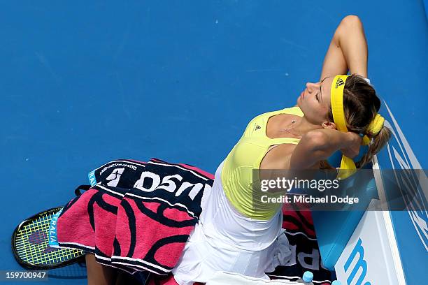 Maria Kirilenko of Russia changes her visor to a headband before her third round match against Jamie Hampton of the United States during day six of...