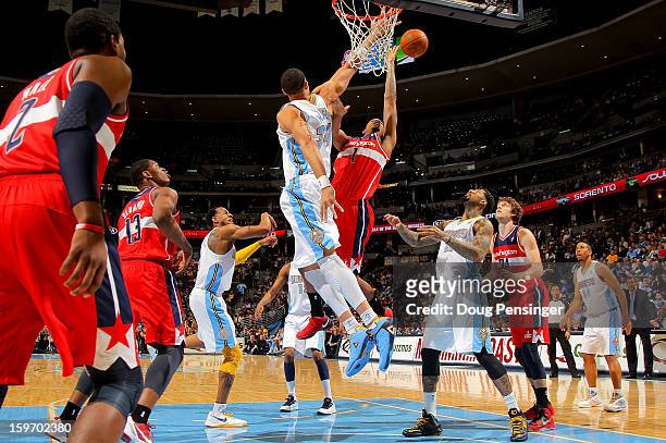 Trevor Ariza of the Washington Wizards takes a shot against JaVale McGee of the Denver Nuggets at the Pepsi Center on January 18, 2013 in Denver,...