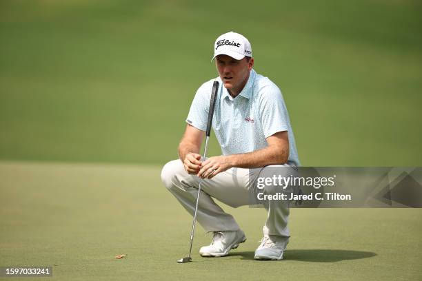 Russell Henley of the United States lines up a putt on the 12th green during the final round of the Wyndham Championship at Sedgefield Country Club...