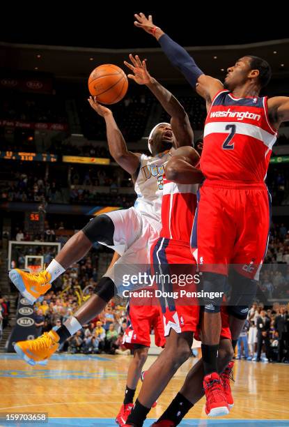 Ty Lawson of the Denver Nuggets has his shot blocked by John Wall of the Washington Wizards with 2.7 seconds remaining in the game at the Pepsi...