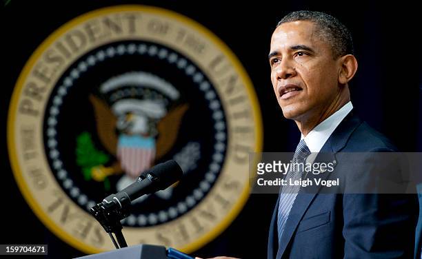 President Barack Obama signs executive orders designed to reduce gun violence in the United States in the Eisenhower Executive Building on January...
