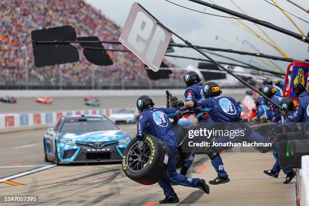 The pit crew of the Auto-Owners Insurance Toyota, driven by Martin Truex Jr., leaps into action during the NASCAR Cup Series FireKeepers Casino 400...