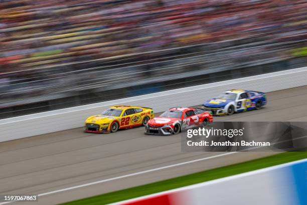 Joey Logano, driver of the Shell Pennzoil Ford, Bubba Wallace, driver of the DoorDash Toyota, and Chase Elliott, driver of the NAPA Auto Parts...