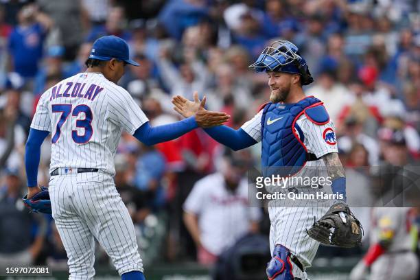 Adbert Alzolay and Tucker Barnhart of the Chicago Cubs celebrate the 6-4 win against the Atlanta Braves at Wrigley Field on August 06, 2023 in...