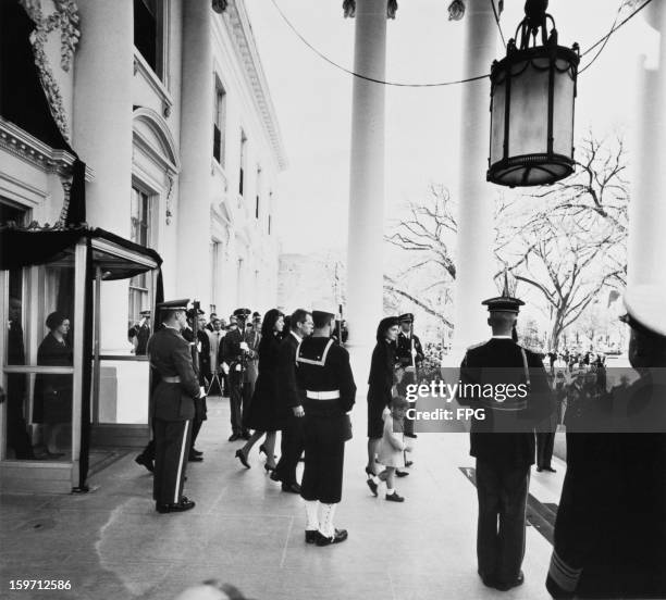Jacqueline Kennedy leaves the White House with her children Caroline Kennedy and John F. Kennedy, Jr. During the funeral of assassinated president...