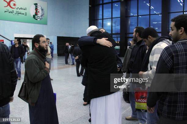 Freed Algerian hostage hugs a relative at Algiers airport after he was released by Islamist captors, alongside other Algerian hostages, from a gas...